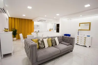 a living room with a couch and a kitchen at Pérola dos Anjos by LovelyStay in Funchal