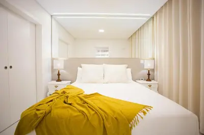 a bedroom with a bed with a yellow blanket on it at Pérola dos Anjos by LovelyStay in Funchal