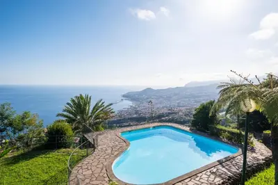 a swimming pool with a view of the ocean at Tucha's Apartement in Funchal