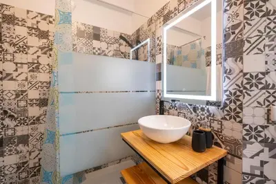 a bathroom with a sink and a mirror at Tucha's Apartement in Funchal