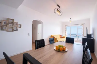 a dining room table with a plate of fruit on it at Tucha's Apartement in Funchal