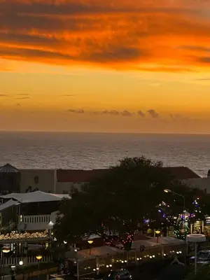 a sunset over the ocean and a city at Lido Casa by Olá Madeira in Funchal