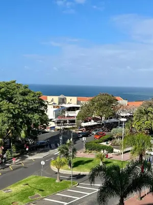 a city street with a parking lot and the ocean at Lido Casa by Olá Madeira in Funchal