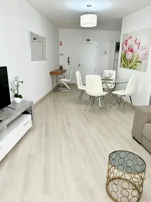 a living room with a couch and a table and chairs at Lido Casa by Olá Madeira in Funchal