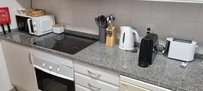 a kitchen with a counter top with a microwave at Marear in Porto Santo