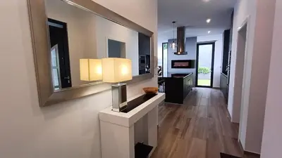 a hallway of a home with a table and mirrors at Casa da Arvore im Eukalyptuswald in Cova do Moirão
