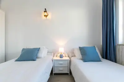 two beds sitting next to each other in a room at Bela Vista Burgau in Burgau
