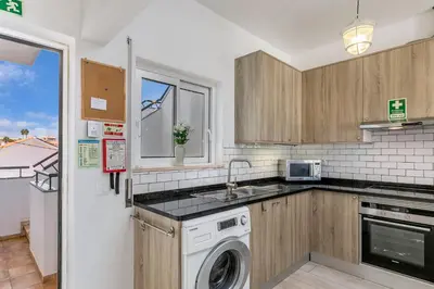 a kitchen with a sink and a dishwasher at Bela Vista Burgau in Burgau