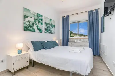 a bedroom with a large bed and a window at Bela Vista Burgau in Burgau