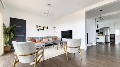 a living room with a couch and a table and chairs at Costa Vista by LovelyStay in Funchal