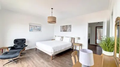 a bedroom with a bed and a desk and a chair at Costa Vista by LovelyStay in Funchal