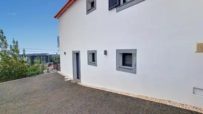 a white building with windows on the side of it at Costa Vista by LovelyStay in Funchal