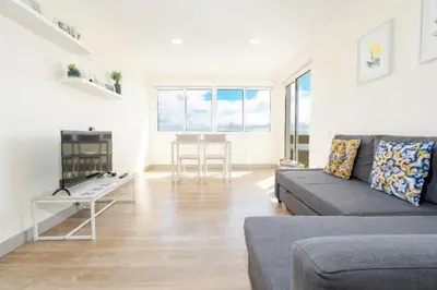 a living room with a couch and a table at The Great Pearl Ocean Views Near Beach & Airport in Machico