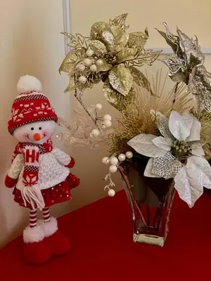 a snowman figurine next to a vase with flowers at Casa Gomes in Calheta