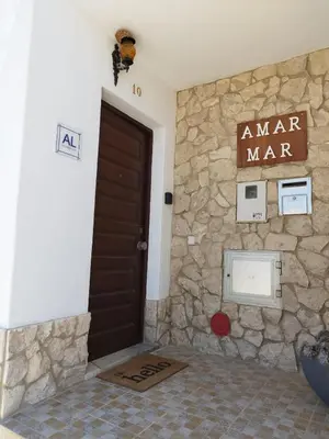 a room with a stone wall and a door at Amar Mar in Vila do Bispo