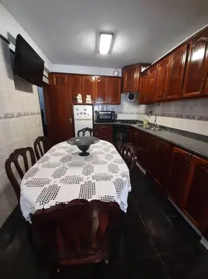 a kitchen with a table with a white table cloth on it at Amar Mar in Vila do Bispo