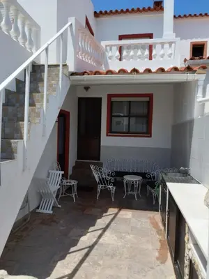 a patio with chairs and a table in a house at Amar Mar in Vila do Bispo