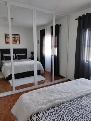 a bedroom with two beds and a large mirror at Amar Mar in Vila do Bispo