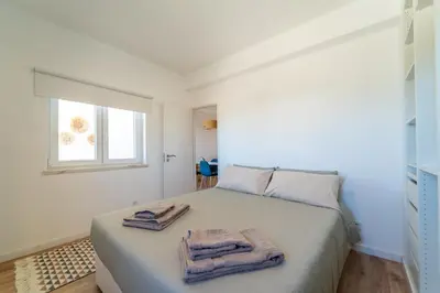 a bedroom with a bed with towels on it at Arrifana Sunset & Ocean View in Aljezur