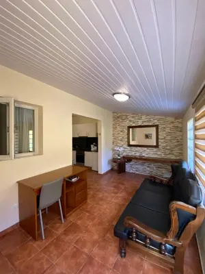 a living room with a couch and a table at caminho da praia da maiata in Porto da Cruz