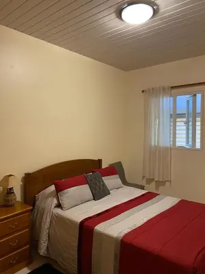 a bedroom with a bed and a window at caminho da praia da maiata in Porto da Cruz