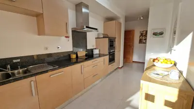 a kitchen with a bowl of fruit on a counter at Luxury apartment at Baia da Luz in Luz