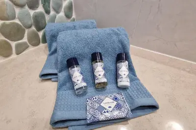a blue towel with two bottles of ingrediantspectspectspectssenalsenalsenalsenal at Luxury apartment at Baia da Luz in Luz
