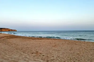 a sandy beach with the ocean in the background at Luxury apartment at Baia da Luz in Luz