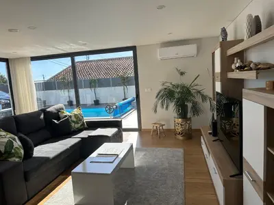 a living room with a couch and a table at Casa Paradiso in Arco da Calheta