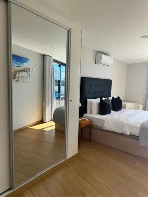 a bedroom with a bed and a large mirror at Casa Paradiso in Arco da Calheta