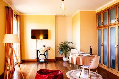 a room with a table with chairs and a lamp at Namastê House II in Funchal