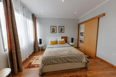 a bedroom with a large bed with yellow pillows at sweet home in Caniçal