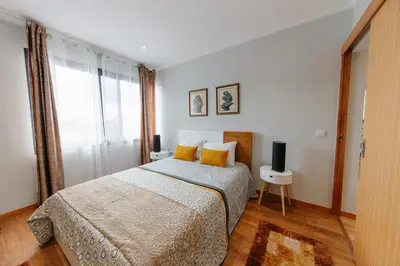 a bedroom with a bed and a large window at sweet home in Caniçal
