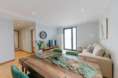 a living room with a table and a couch at sweet home in Caniçal