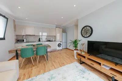 a kitchen and living room with a couch and a table at sweet home in Caniçal