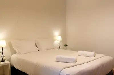 a bedroom with a large white bed with two towels on it at GuestReady - A sunny delight in Funchal in Funchal