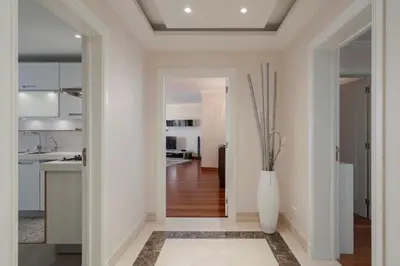 a hallway with a white vase on the floor at Vila Formosa II by An Island Apart in Funchal