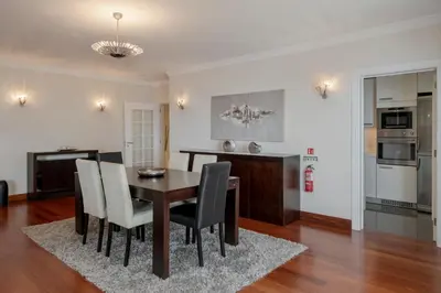 a dining room and kitchen with a table and chairs at Vila Formosa II by An Island Apart in Funchal