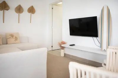 a living room with a flat screen tv on a wall at TAC - Sagres Studio in Sagres