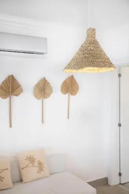 a pendant light with three umbrellas hanging on a wall at TAC - Sagres Studio in Sagres