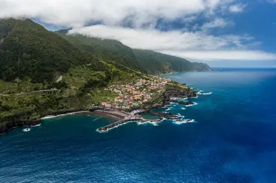 an aerial view of a small island in the ocean at Pipas do Avô - Seixal by An Island Apart in Porto Moniz