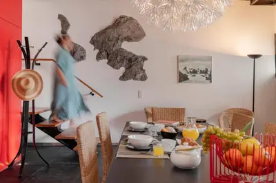 a dining room with a table with food on it at Pipas do Avô - Seixal by An Island Apart in Porto Moniz