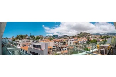 a bedroom with a large bed with a large window at Freemont Apartment Funchal in Funchal