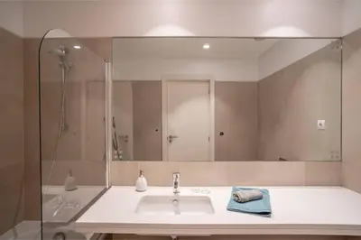 a bathroom with a white toilet and a mirror at Freemont Apartment Funchal in Funchal