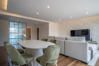 a living room with a couch and a table and chairs at Freemont Apartment Funchal in Funchal