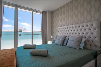 a bedroom with a large bed with a large window at Freemont Apartment Funchal in Funchal