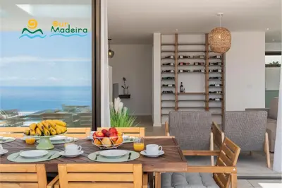 a dining room with a table with fruit on it at OurMadeira - Calheta Pearl in Estreito da Calheta