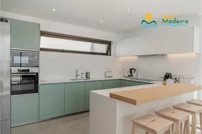 a kitchen with blue cabinets and a counter top at OurMadeira - Calheta Pearl in Estreito da Calheta