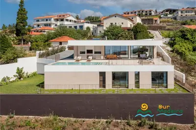 an aerial view of a house with a swimming pool at OurMadeira - Calheta Pearl in Estreito da Calheta