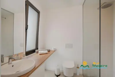 a white bathroom with a sink and a mirror at OurMadeira - Calheta Pearl in Estreito da Calheta